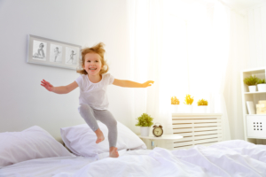 Girl jumping on the bed